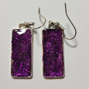 Purple glitter earrings.